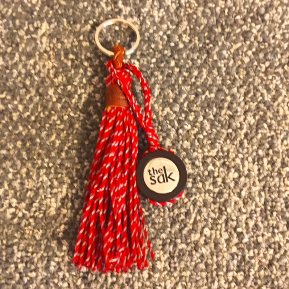 The Sak red and brown leather keychain the Sak emblem